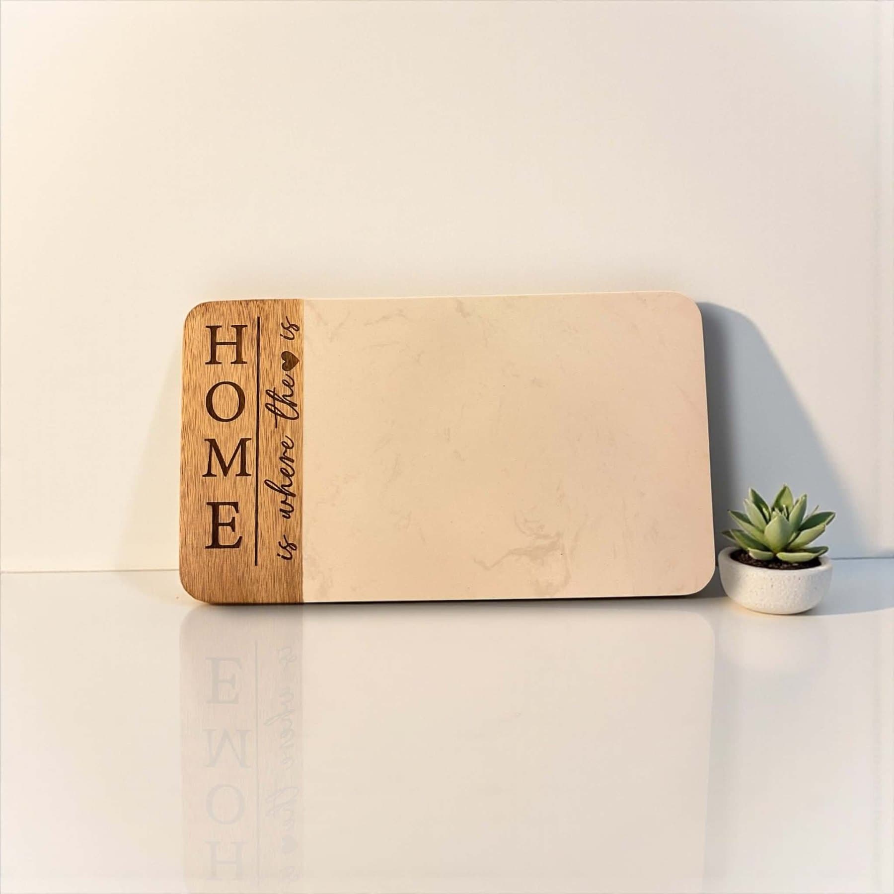 Marble and acacia board engraved with Home is where the heart is